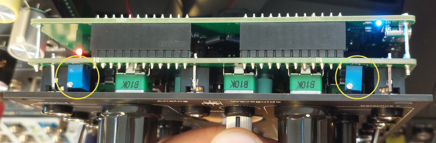 The two X OFST and Y OFST trimmers on top of the module, marked with yellow circles.