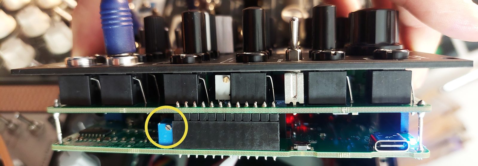 The Y Gain trimmer directly under the frontplate on the right side of the module, marked with a yellow circle.