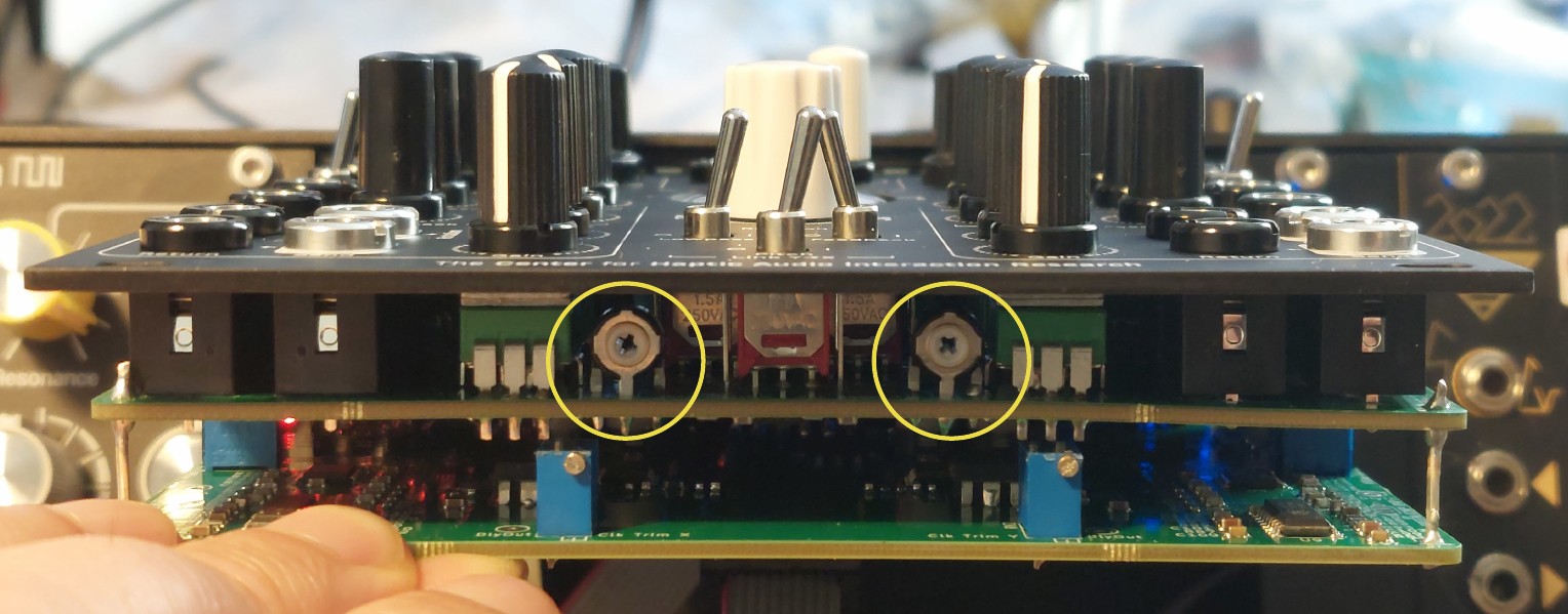 The two Decay Boost X and Y trimmers directly under the frontplate, marked with yellow circles.
